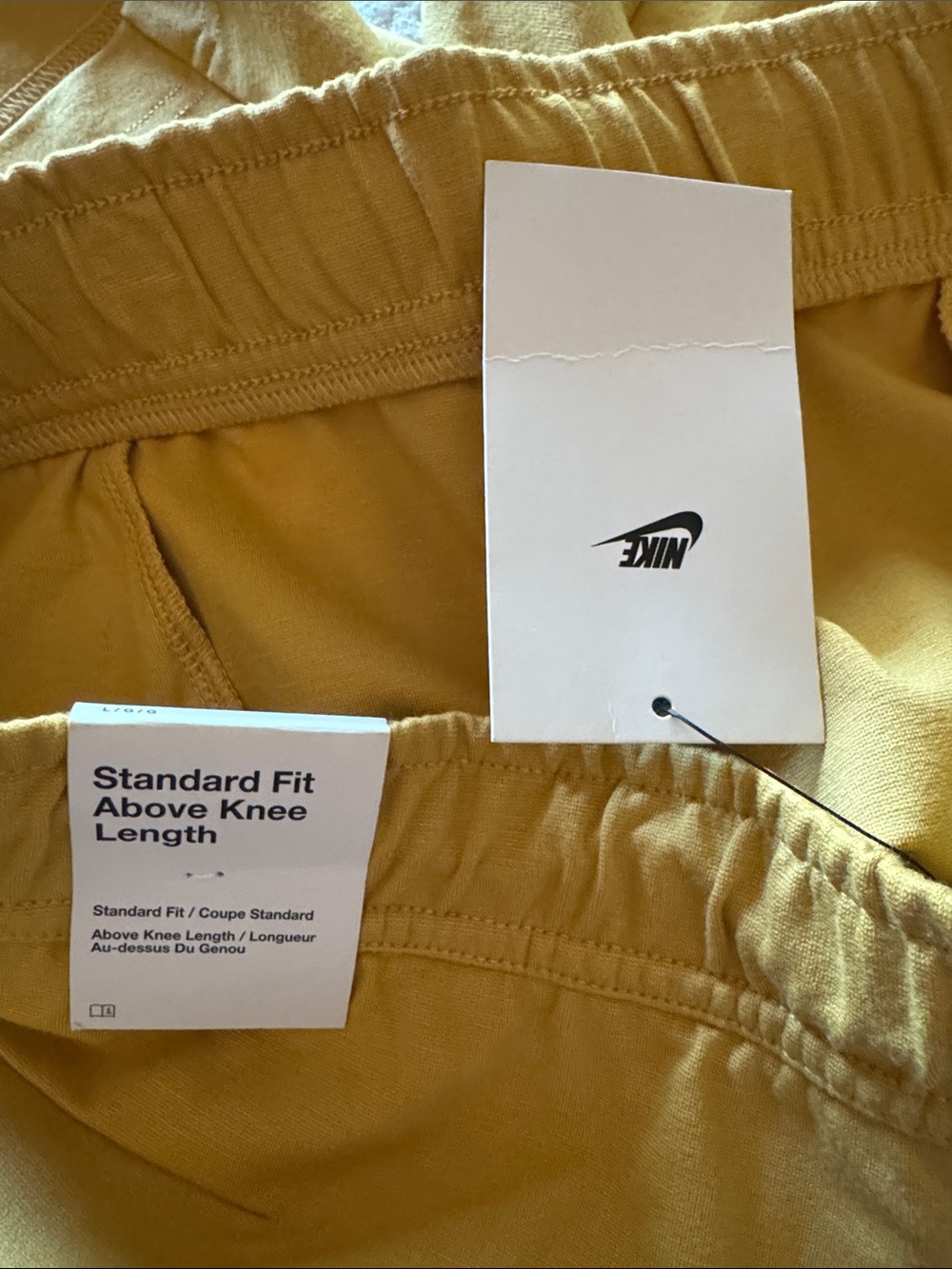 Nike Men's Large Gold Athletic Drawstring Shorts with Black accents.